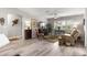 Inviting living room features wood floors, fan, plantation shutters and comfortable seating area at 13715 Se 88Th Ct, Summerfield, FL 34491