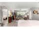 Open-concept living space features wood floors, plantation shutters and comfortable seating at 13715 Se 88Th Ct, Summerfield, FL 34491