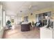 Relaxing sun room featuring tile floors, multiple ceiling fans and sliding glass doors at 13715 Se 88Th Ct, Summerfield, FL 34491