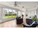 Bright sunroom with tile flooring, ceiling fans, and views of the manicured backyard at 13715 Se 88Th Ct, Summerfield, FL 34491