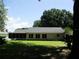 Spacious backyard showcasing a screened-in porch, lush greenery, and mature trees for privacy at 14192 Sw 112Th Cir, Dunnellon, FL 34432