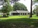Spacious backyard featuring a hammock and a screened-in porch for outdoor relaxation at 14192 Sw 112Th Cir, Dunnellon, FL 34432