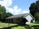 Lush backyard with a screen room, mature trees, bird bath and a well-maintained lawn at 14192 Sw 112Th Cir, Dunnellon, FL 34432