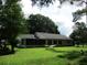 Expansive backyard with a relaxing hammock and screened in porch, perfect for outdoor living at 14192 Sw 112Th Cir, Dunnellon, FL 34432