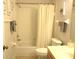 Bathroom showcasing a tub with shower, neutral wall art, and standard toilet and fixtures at 14192 Sw 112Th Cir, Dunnellon, FL 34432