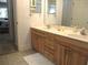 Bathroom vanity with double sinks, ample counter space, and wooden cabinets providing a touch of warmth at 14192 Sw 112Th Cir, Dunnellon, FL 34432