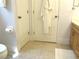 Bright bathroom featuring neutral tile, a white robe, and a wooden vanity at 14192 Sw 112Th Cir, Dunnellon, FL 34432