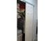 Organized reach-in bedroom closet with ample hanging space and storage, showcasing its functional design at 14192 Sw 112Th Cir, Dunnellon, FL 34432
