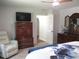 Well-appointed bedroom with a TV, closet, and a view into another room, offering a comfortable and connected space at 14192 Sw 112Th Cir, Dunnellon, FL 34432