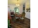 Bright dining room featuring wood floors, an elegant table, and a beautiful sailboat painting at 14192 Sw 112Th Cir, Dunnellon, FL 34432