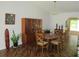 Bright dining room featuring wood floors, an elegant table, and a beautiful built-in cabinet at 14192 Sw 112Th Cir, Dunnellon, FL 34432
