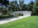Charming single-story home featuring a manicured lawn, attached garage, and an inviting exterior at 14192 Sw 112Th Cir, Dunnellon, FL 34432