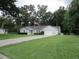 Charming home with a well-manicured lawn, fenced-in yard, and an American flag at 14192 Sw 112Th Cir, Dunnellon, FL 34432