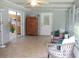 Enclosed Florida room with sliding glass door and wicker seating arrangement at 14192 Sw 112Th Cir, Dunnellon, FL 34432