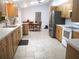 Spacious kitchen featuring light wood cabinets, modern appliances, and tile flooring at 14192 Sw 112Th Cir, Dunnellon, FL 34432