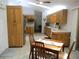 Cozy kitchen and dining area with warm tones, featuring modern appliances and wooden accents at 14192 Sw 112Th Cir, Dunnellon, FL 34432