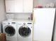 Convenient laundry room featuring a washer, dryer, and extra refrigerator at 14192 Sw 112Th Cir, Dunnellon, FL 34432