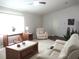 Bright living room with comfortable seating, wood accents, and large windows offering a relaxing space at 14192 Sw 112Th Cir, Dunnellon, FL 34432