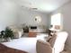 Well-lit living room featuring neutral decor, comfortable seating arrangements, and a ceiling fan at 14192 Sw 112Th Cir, Dunnellon, FL 34432