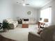 Bright living room with neutral walls, plush seating, a ceiling fan, and natural light for a comfortable space at 14192 Sw 112Th Cir, Dunnellon, FL 34432
