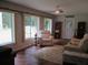 Cozy living room filled with natural light from the large windows and decorated with a stylish rug and comfy seating at 14192 Sw 112Th Cir, Dunnellon, FL 34432