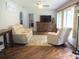 Comfortable living room with recliner seating, wood-look flooring and ceiling fan at 14192 Sw 112Th Cir, Dunnellon, FL 34432