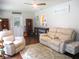 Bright living room with recliner seating, rustic accents and wood-look floors at 14192 Sw 112Th Cir, Dunnellon, FL 34432