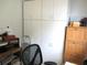 Home office with built-in white cabinets, desk and sewing machine at 14192 Sw 112Th Cir, Dunnellon, FL 34432