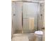 Bathroom with a glass-enclosed shower and neutral tile, offering a clean aesthetic at 14192 Sw 112Th Cir, Dunnellon, FL 34432