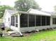 Exterior of home featuring a large sunroom with sliding windows leading to the fenced backyard at 14192 Sw 112Th Cir, Dunnellon, FL 34432