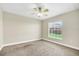 Neutral bedroom featuring a ceiling fan and a window allowing in natural light at 145 Harbor Way, Auburndale, FL 33823