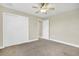 Neutral bedroom featuring a ceiling fan, carpeting, and closet at 145 Harbor Way, Auburndale, FL 33823
