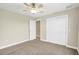 Neutral bedroom with a ceiling fan, carpeting, closet, and a view of the entry at 145 Harbor Way, Auburndale, FL 33823