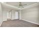 Spacious bedroom with a tray ceiling, ceiling fan, neutral paint, and carpet flooring at 145 Harbor Way, Auburndale, FL 33823