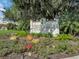 Community entrance sign that says 'Ariana Harbor' surrounded by landscaping and flowers at 145 Harbor Way, Auburndale, FL 33823