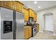 This well-equipped kitchen includes stainless steel appliances, tile flooring, and wood cabinets at 145 Harbor Way, Auburndale, FL 33823