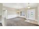 Open-concept living room with tile entry, carpet, and views of the dining area at 145 Harbor Way, Auburndale, FL 33823