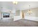Spacious living room with carpet floors, ceiling fans, and sliding glass doors leading to the outside patio at 145 Harbor Way, Auburndale, FL 33823