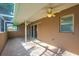A covered patio with ceiling fans, brick flooring, and sliding glass doors for easy indoor-outdoor flow at 145 Harbor Way, Auburndale, FL 33823