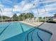 Sparkling pool with screen enclosure, lounge chairs and landscaping at 145 Harbor Way, Auburndale, FL 33823