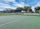 Well-maintained tennis court with basketball hoop, perfect for recreation at 145 Harbor Way, Auburndale, FL 33823