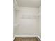 Neutral walk-in closet with wire shelving and neutral carpet flooring at 145 Harbor Way, Auburndale, FL 33823