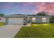 Charming single-story home with a well-manicured lawn, attached garage, and inviting front entrance at 14863 Sw 60Th Ter, Ocala, FL 34473