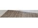 Close up of wood-look laminate flooring with white baseboards at 17277 Sw 44Th Cir, Ocala, FL 34473