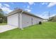 This home includes a two-car garage and an energy-efficient AC unit surrounded by a lush green lawn at 17277 Sw 44Th Cir, Ocala, FL 34473