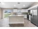 Modern kitchen boasting stainless steel appliances, white cabinetry and granite countertops at 17277 Sw 44Th Cir, Ocala, FL 34473