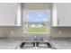 Close-up of the kitchen sink and window showing the outside of the property at 17277 Sw 44Th Cir, Ocala, FL 34473