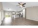 Open-concept living room and kitchen featuring stainless steel appliances and luxury vinyl flooring at 17277 Sw 44Th Cir, Ocala, FL 34473