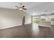 Bright and open living room featuring luxury vinyl flooring, modern ceiling fan and sliding glass doors at 17277 Sw 44Th Cir, Ocala, FL 34473
