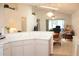 Open living space with vaulted ceiling and adjacent dining area featuring light tile floors and plenty of natural light at 17720 Se 115Th Ct, Summerfield, FL 34491